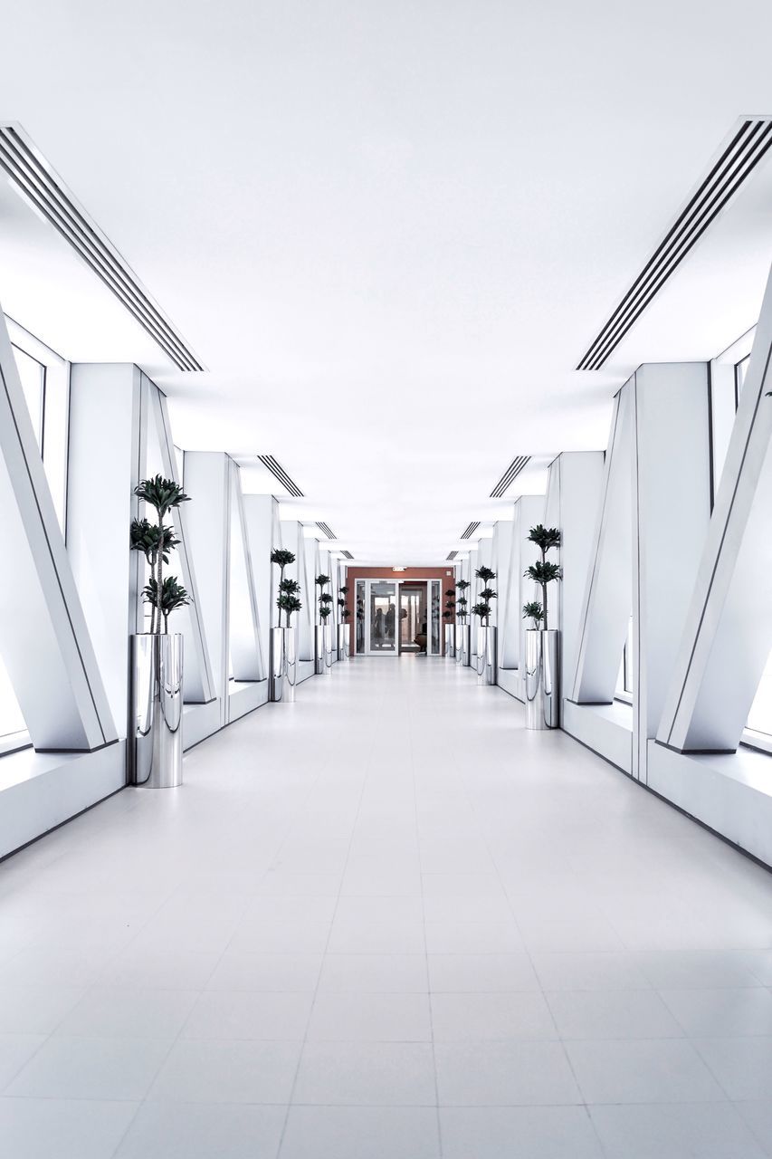 the way forward, architecture, direction, built structure, flooring, empty, building, indoors, diminishing perspective, absence, modern, arcade, no people, corridor, tiled floor, day, railing, sky, ceiling, tile, long