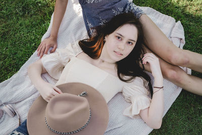 High angle view portrait of woman lying on field