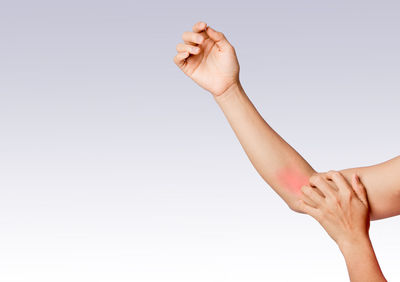 Close-up of woman hand against white background