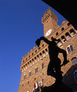 Low angle view of historic building against clear blue sky