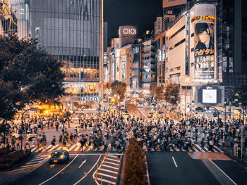 Crowd on city street at night