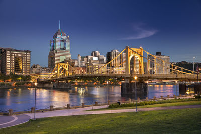 Illuminated buildings in city at waterfront