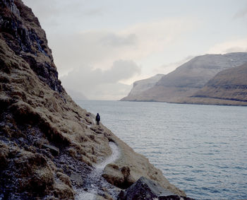 Scenic view of sea and mountains against sky