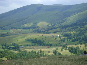 Scenic view of green landscape against sky