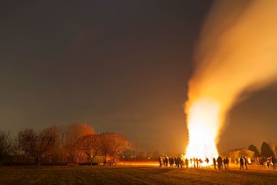 Group of people on field at night