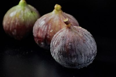 Close-up of lemon on table against black background