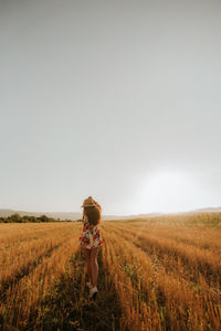 Man standing on field against sky