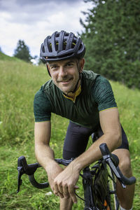 Portrait of man riding bicycle outdoors