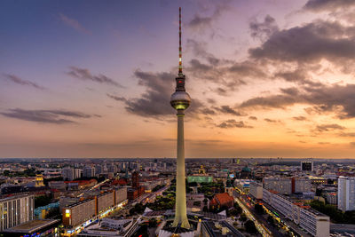 Fernsehturm against sky during sunset