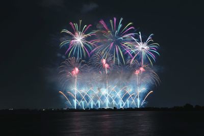 Low angle view of firework display at night