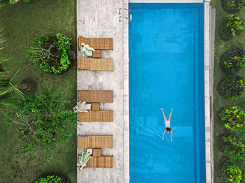 Aerial view of attractive woman floating over water at resort