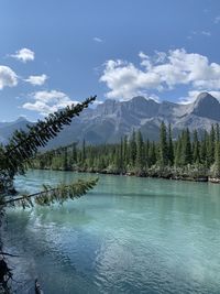 Scenic and tranquil view of aquamarine river with mountainous background 