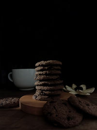 Close-up of cookies on table against black background