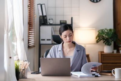 Young businesswoman working at table