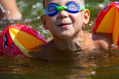 Portrait of smiling man swimming in pool