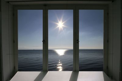 Scenic view of sea against sky seen through window