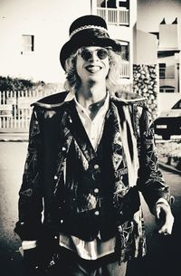 Portrait of young man wearing sunglasses standing outdoors