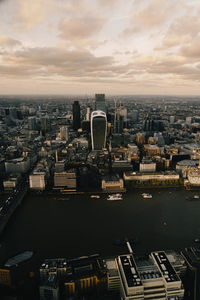 High angle view of buildings in city at sunset