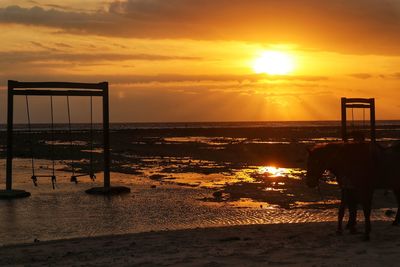 Scenic view of sea against orange sky