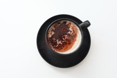 High angle view of coffee cup against white background