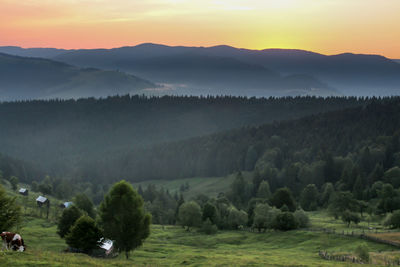 Scenic view of landscape against sky during sunset