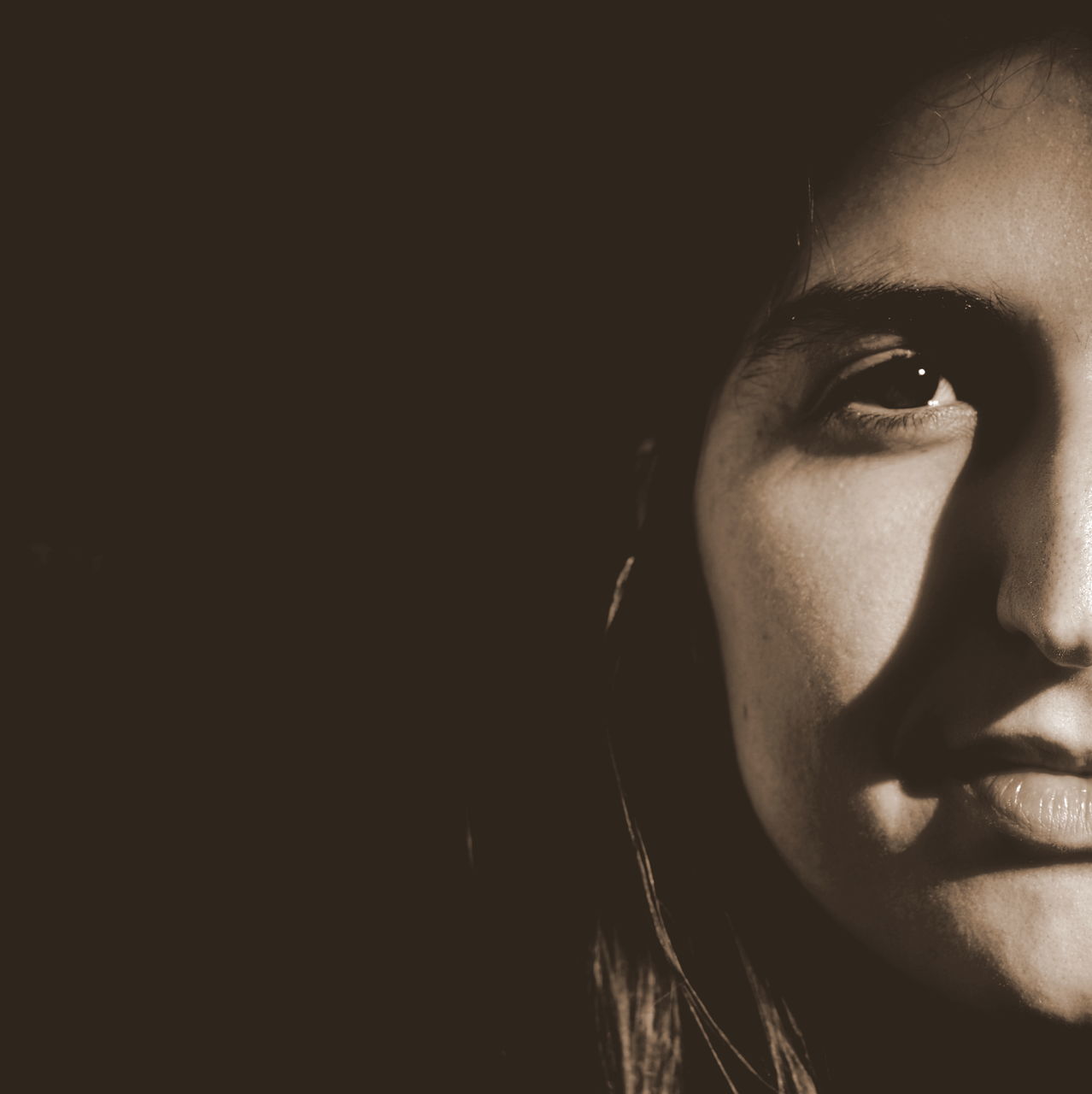 studio shot, black background, headshot, young adult, human face, portrait, close-up, looking at camera, front view, person, young women, lifestyles, copy space, indoors, head and shoulders, serious, contemplation