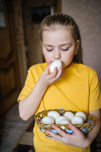 Girl with a basket of white easter eggs