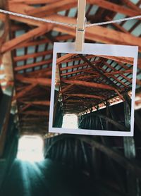 Close-up of photograph in covered wooden footbridge