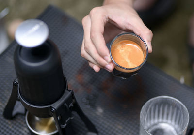 Midsection of man holding coffee
