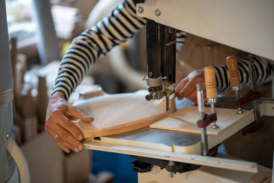 Midsection of man working at workshop