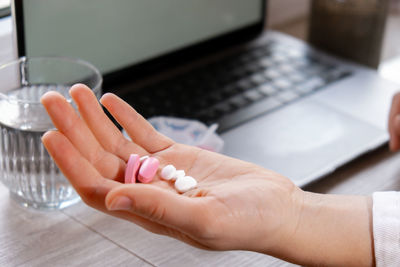 Cropped hand of person working on table