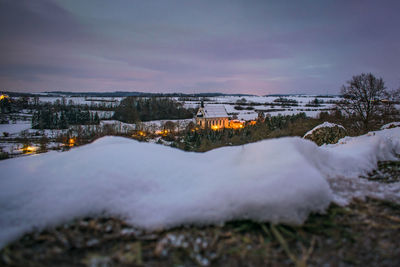 Scenic view of illuminated city against sky during winter