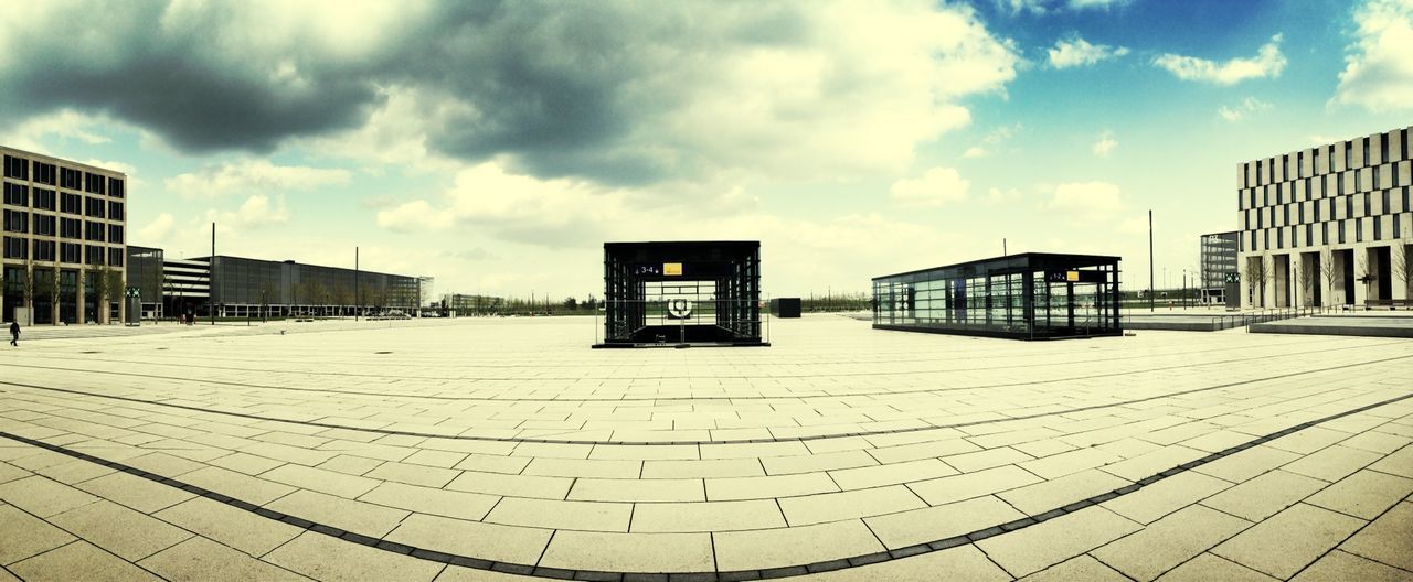 sky, built structure, architecture, building exterior, cloud - sky, cloudy, cloud, empty, outdoors, day, city, absence, cobblestone, the way forward, in a row, building, no people, pattern, footpath, weather