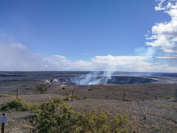 Smoke erupting at kilauea against sky