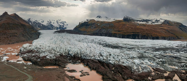 Beautiful glaciers flow through the mountains in iceland.