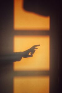 Shadow of person hand on wall