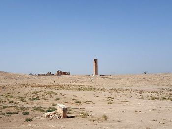 Scenic view of desert against clear blue sky