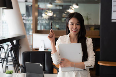 Portrait of woman working with smart phone