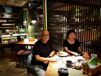 Portrait of friends sitting at restaurant table