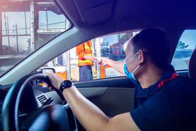 Man sitting in car