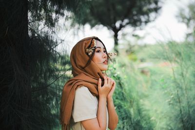 Young woman in headscarf looking away