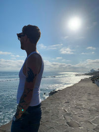 Man standing on beach against sky