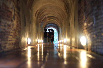 Rear view of man walking in tunnel