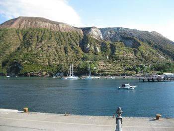 Scenic view of sea and mountains against sky