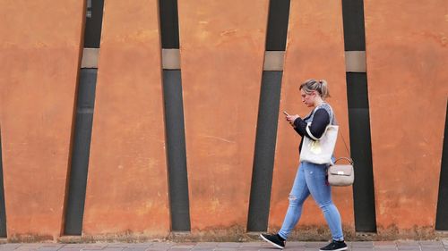 Woman standing against wall