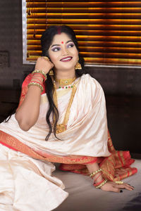 Portrait of young woman sitting outdoors