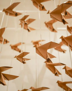 Close-up of paper toy hanging against white wall