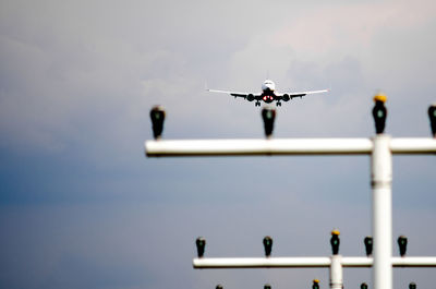 Low angle view of airplane flying against sky