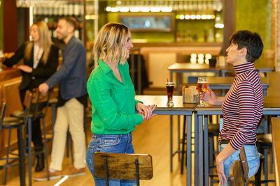 Rear view of young woman standing in store