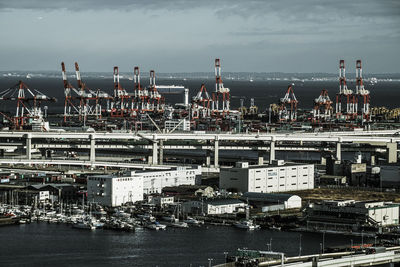 Commercial dock by sea against sky